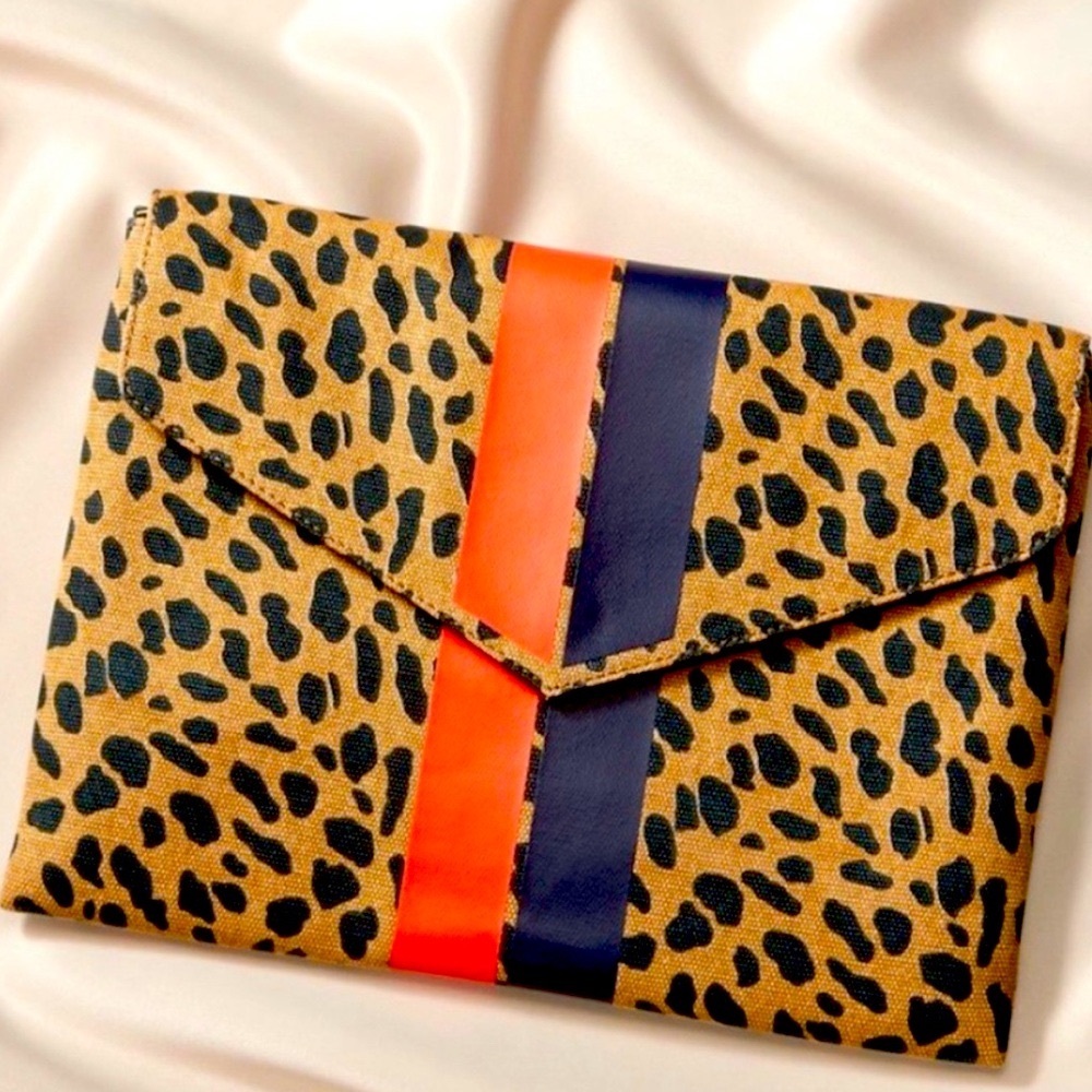 Stella & Dot Animal Print Clutch. Striped interior has 8 credits cards slots.